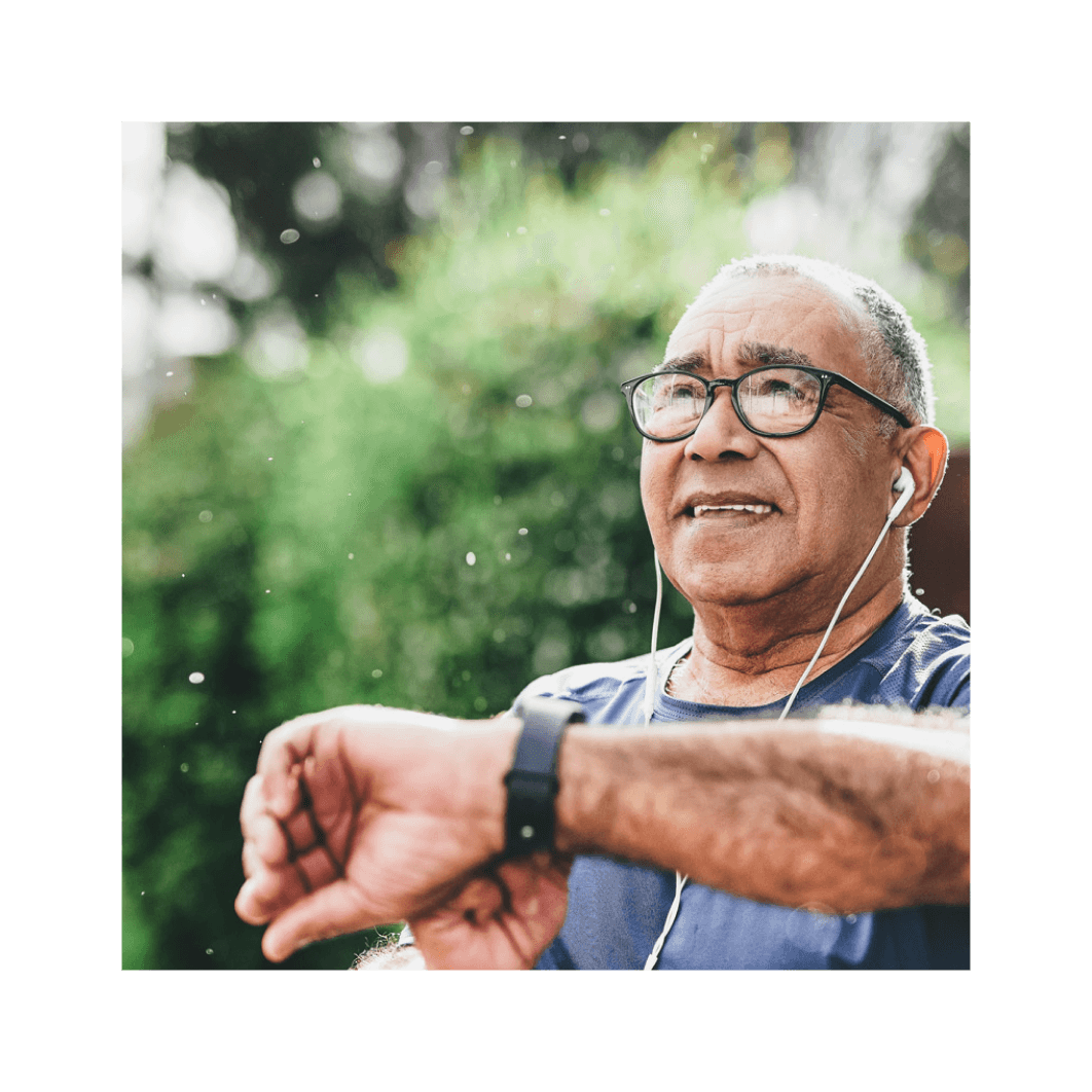 A mature man checking his intelligent watch while jogging